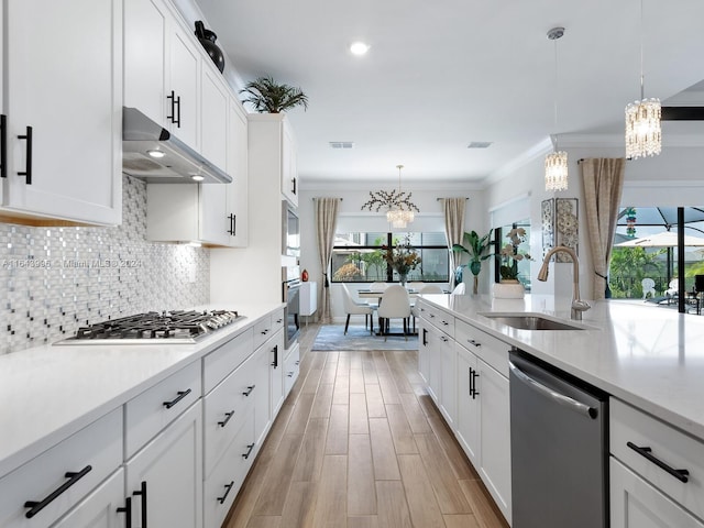 kitchen featuring pendant lighting, stainless steel appliances, sink, and a wealth of natural light