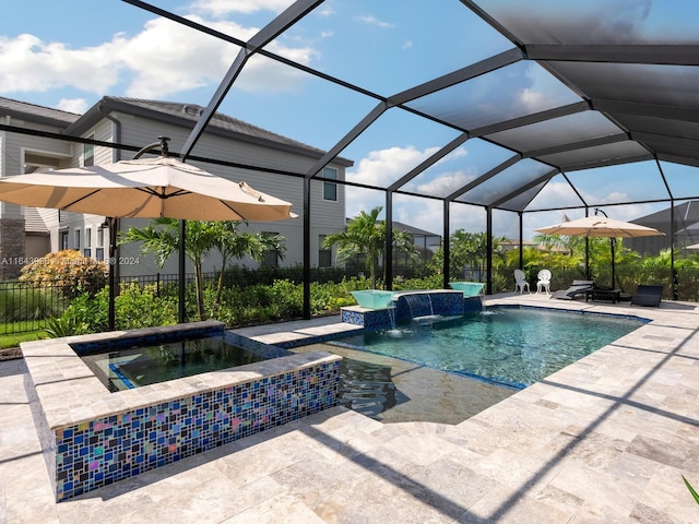 view of pool with a patio area, pool water feature, an in ground hot tub, and glass enclosure