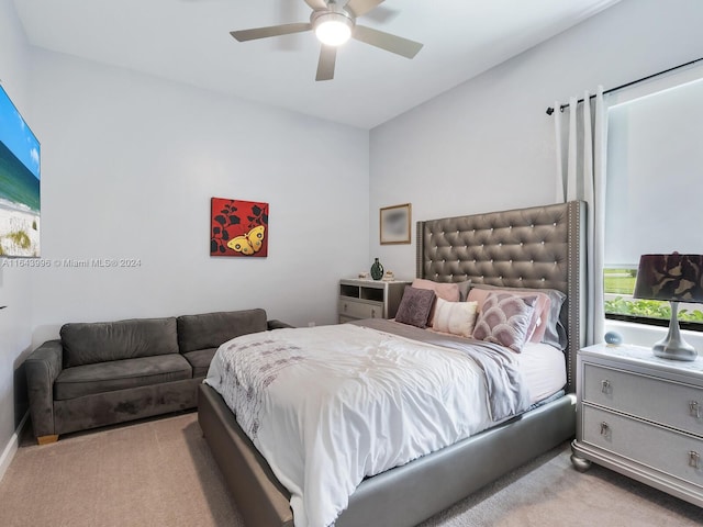 carpeted bedroom with ceiling fan and multiple windows