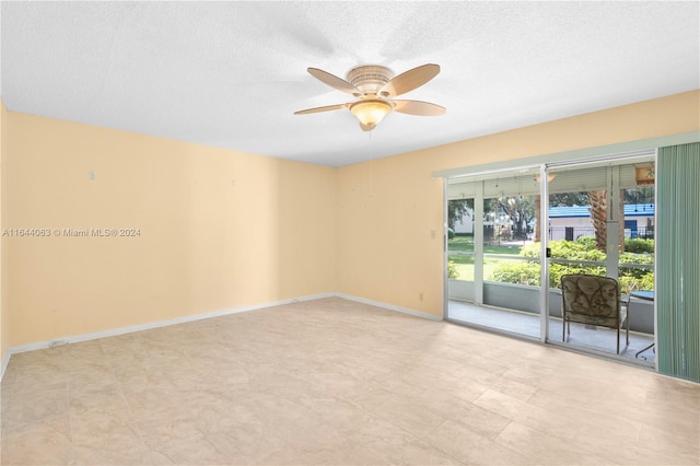 empty room with a textured ceiling and ceiling fan