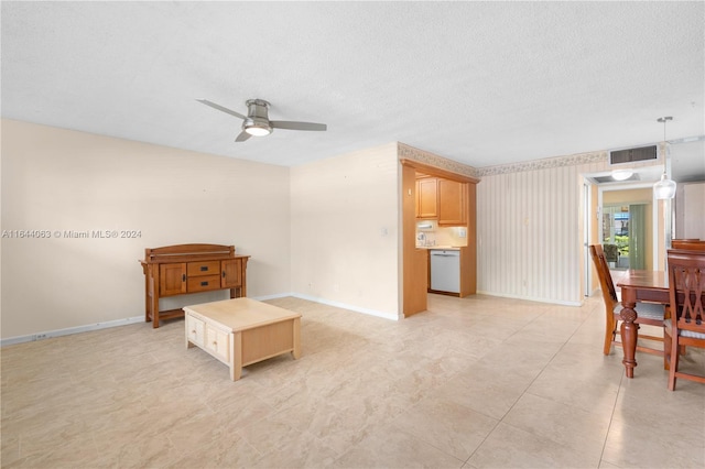 interior space with ceiling fan and a textured ceiling