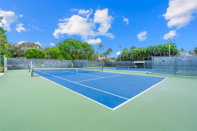 view of tennis court with basketball hoop