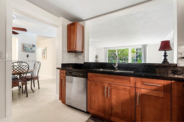 kitchen with ceiling fan, stainless steel dishwasher, backsplash, ornamental molding, and sink