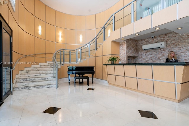 interior space with a high ceiling and a wall unit AC