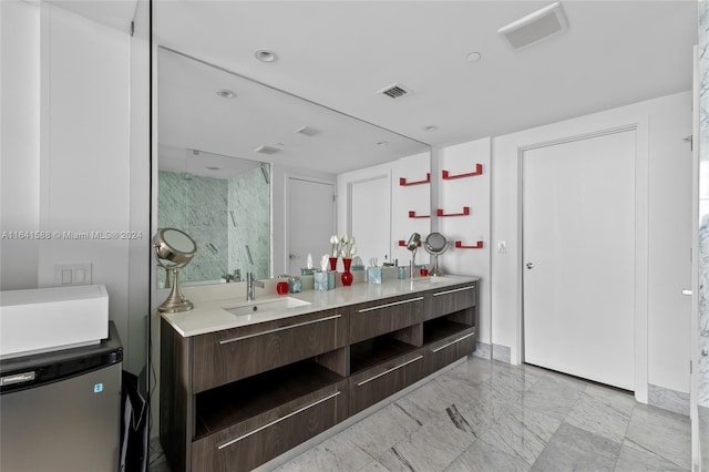 full bathroom featuring marble finish floor, double vanity, a sink, and visible vents