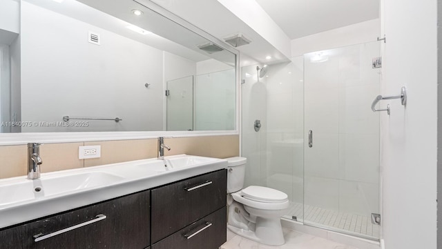 bathroom with vanity, a shower with door, and toilet