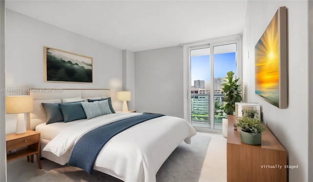 carpeted bedroom featuring multiple windows, access to outside, and a wall of windows