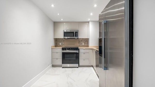 kitchen featuring decorative backsplash and appliances with stainless steel finishes