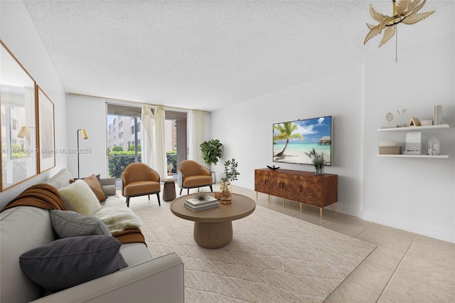 living room featuring a textured ceiling and light tile patterned flooring