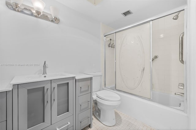 full bathroom featuring tile patterned flooring, toilet, vanity, and combined bath / shower with glass door