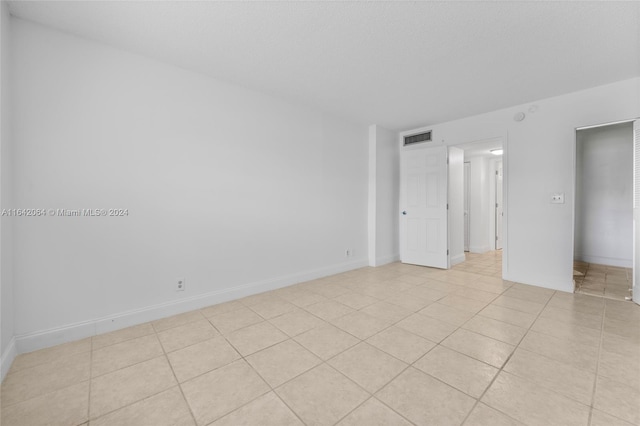 unfurnished bedroom with a closet and light tile patterned flooring