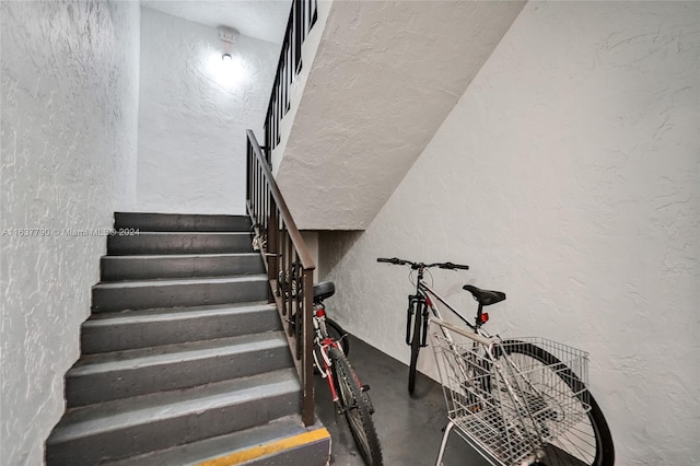 stairway featuring concrete floors