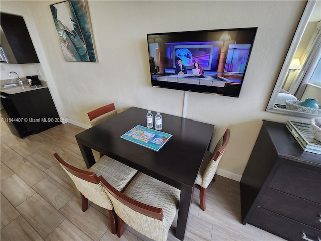 dining room featuring wood tiled floor and baseboards