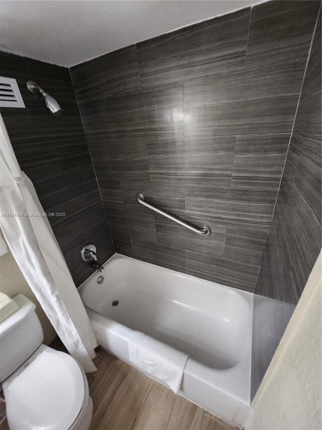 full bathroom with toilet, vanity, and shower / bathtub combination with curtain