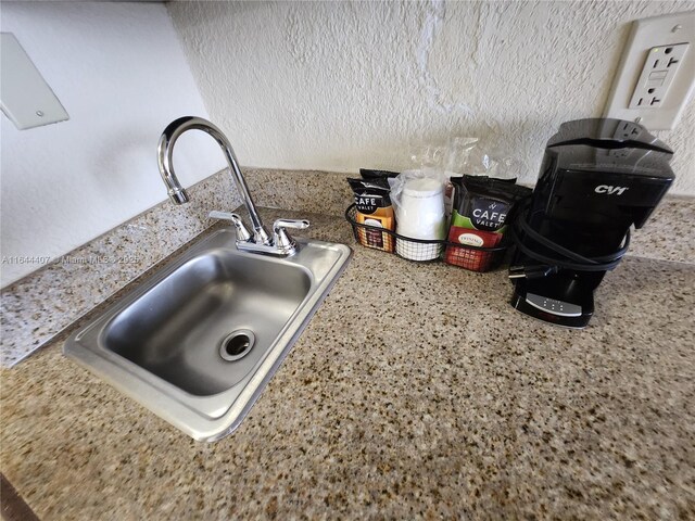 kitchen featuring sink, dishwasher, and light tile patterned floors