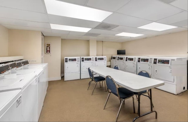 clothes washing area featuring independent washer and dryer and light colored carpet