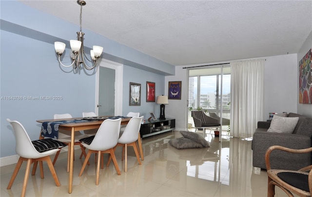 dining room with an inviting chandelier, a textured ceiling, and light tile patterned floors