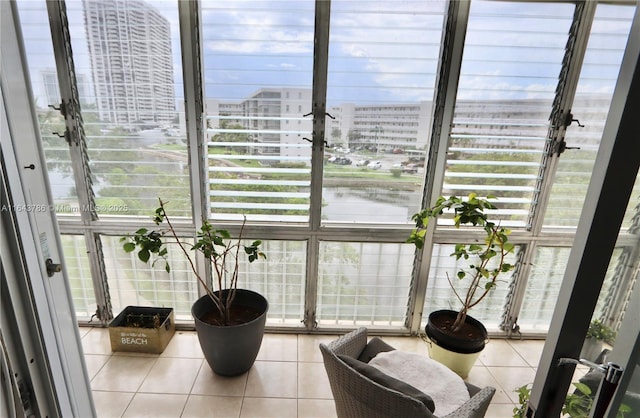 sitting room featuring expansive windows and tile patterned floors