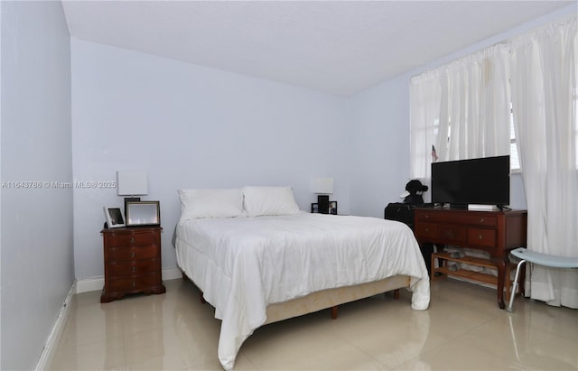 bedroom featuring light tile patterned floors