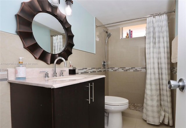 bathroom with tile walls, vanity, toilet, tile patterned floors, and a shower with curtain