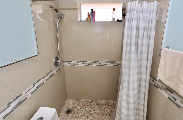 bathroom featuring toilet and walk in shower