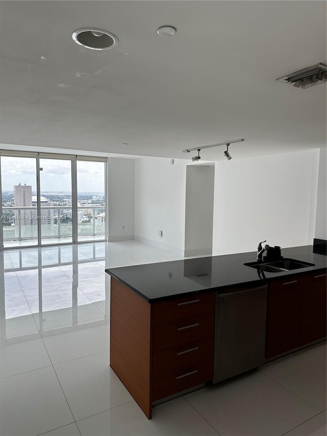 kitchen with light tile patterned floors, rail lighting, sink, and floor to ceiling windows