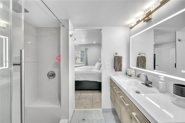 bathroom featuring a shower and vanity