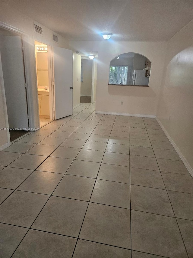 basement featuring light tile patterned floors