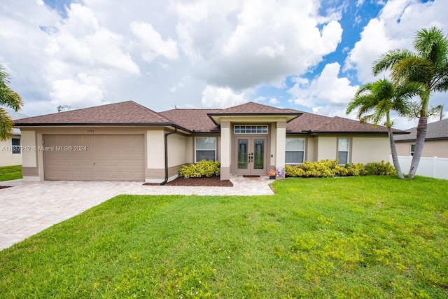 view of front facade featuring a garage, french doors, and a front lawn