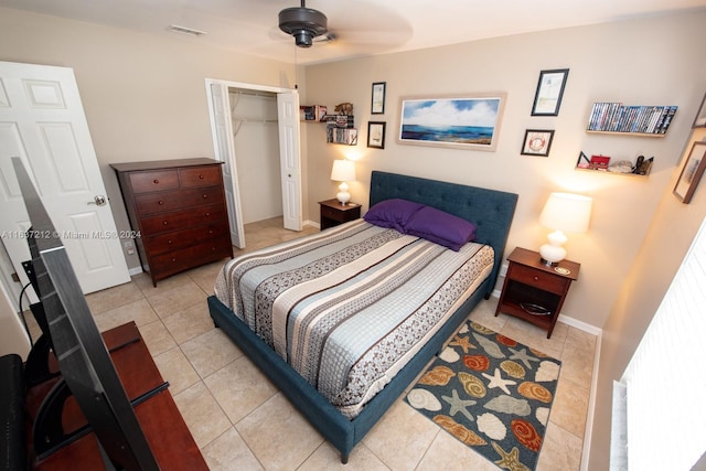 bedroom with light tile patterned floors, ceiling fan, and a closet