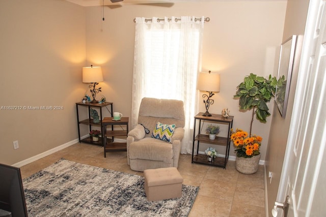 living area featuring ceiling fan and light tile patterned flooring