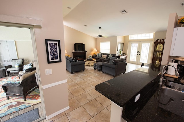 interior space with lofted ceiling, french doors, ceiling fan, and sink