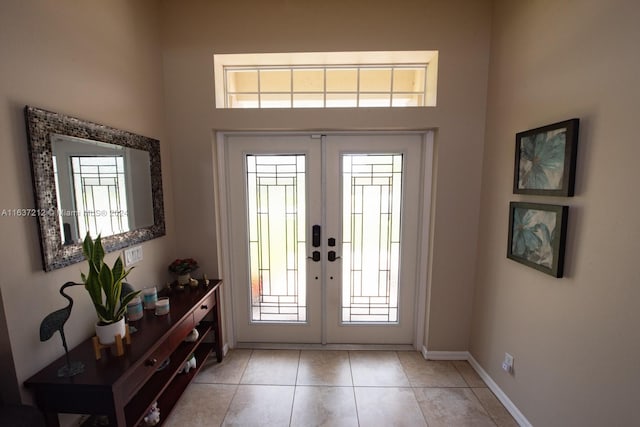 foyer entrance featuring plenty of natural light, light tile patterned floors, and french doors