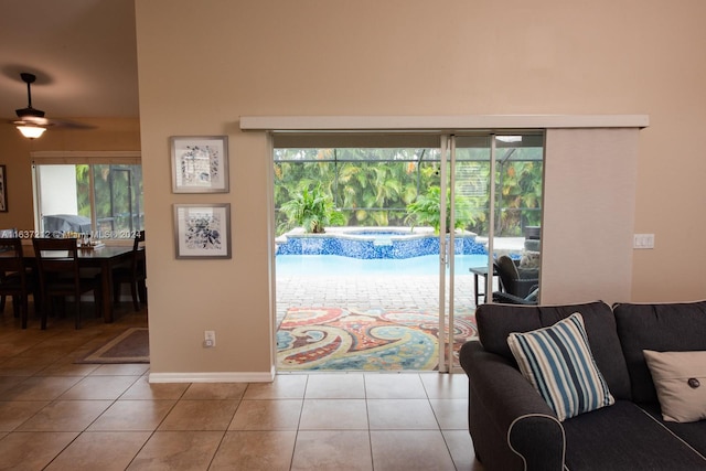 interior space featuring ceiling fan, light tile patterned floors, and plenty of natural light