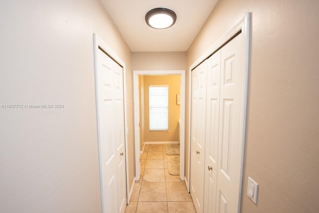 hall with light tile patterned floors