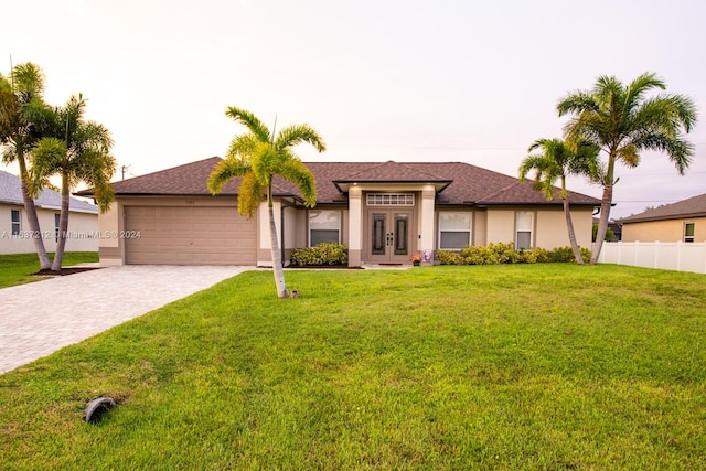 view of front of house with a garage and a front lawn