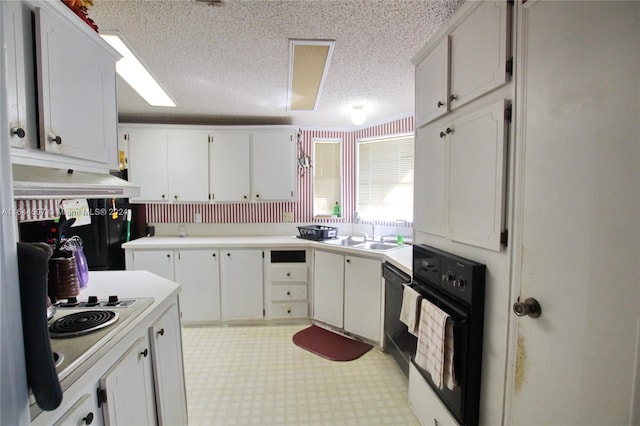 kitchen featuring light tile patterned flooring, sink, a textured ceiling, white cabinetry, and black appliances