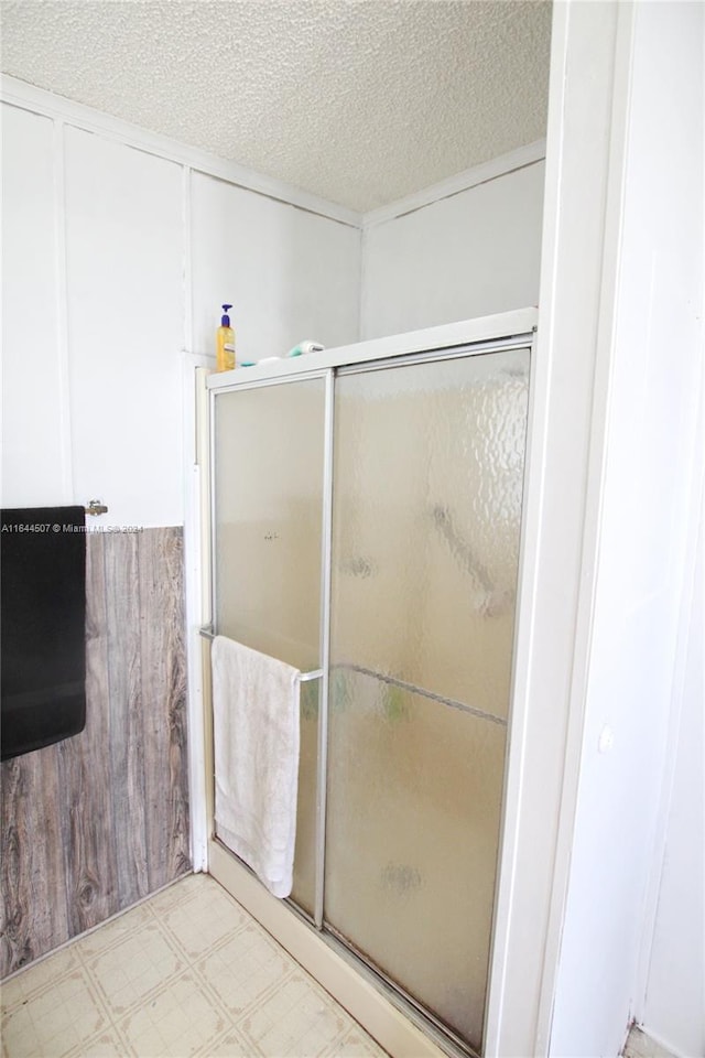 bathroom featuring tile patterned floors and a textured ceiling