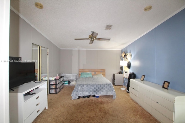 bedroom with a textured ceiling, ceiling fan, ornamental molding, and light colored carpet