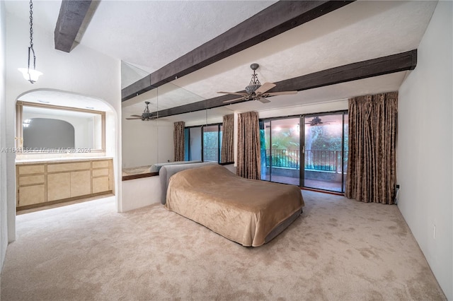 carpeted bedroom with beam ceiling, ensuite bathroom, ceiling fan, a textured ceiling, and access to outside