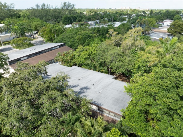 drone / aerial view featuring a wooded view