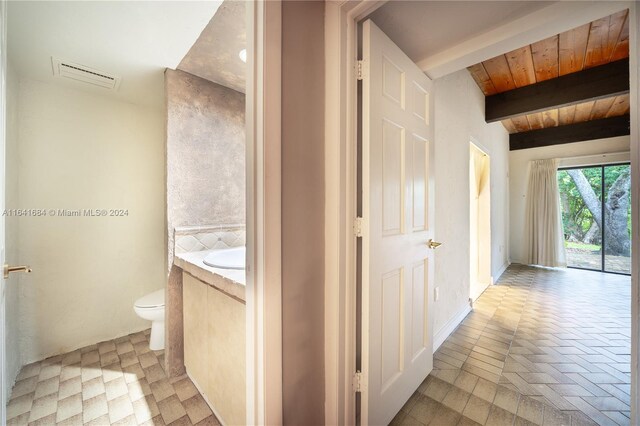 bathroom with beam ceiling, vanity, tile patterned flooring, wood ceiling, and toilet