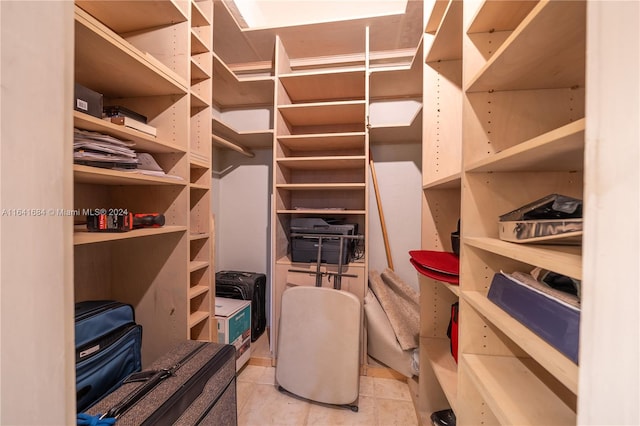 walk in closet with light tile patterned floors