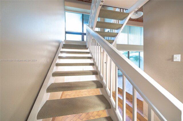 stairs featuring a towering ceiling