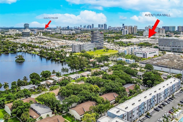 birds eye view of property with a water view and a view of city