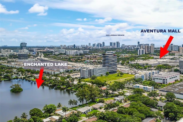 birds eye view of property featuring a water view and a city view