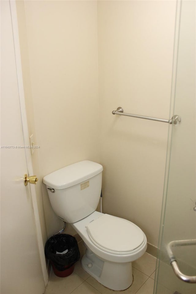 bathroom featuring toilet and tile patterned floors