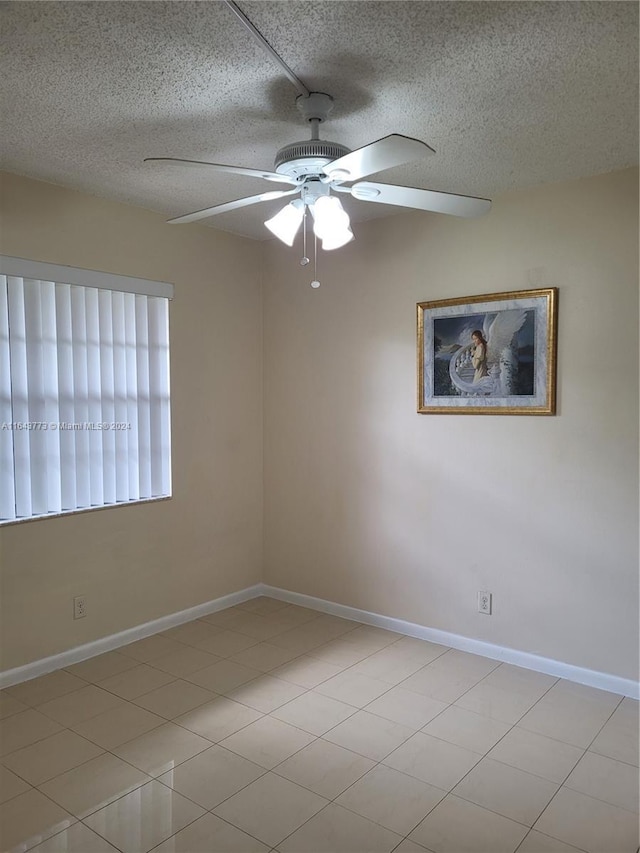 empty room featuring a textured ceiling and ceiling fan