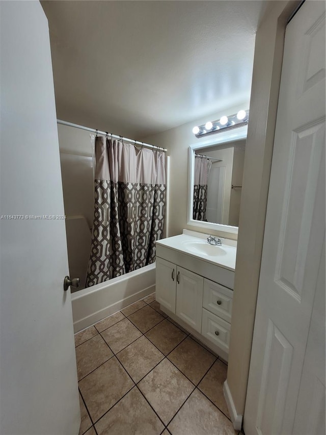 bathroom featuring tile patterned flooring, vanity, and shower / tub combo with curtain