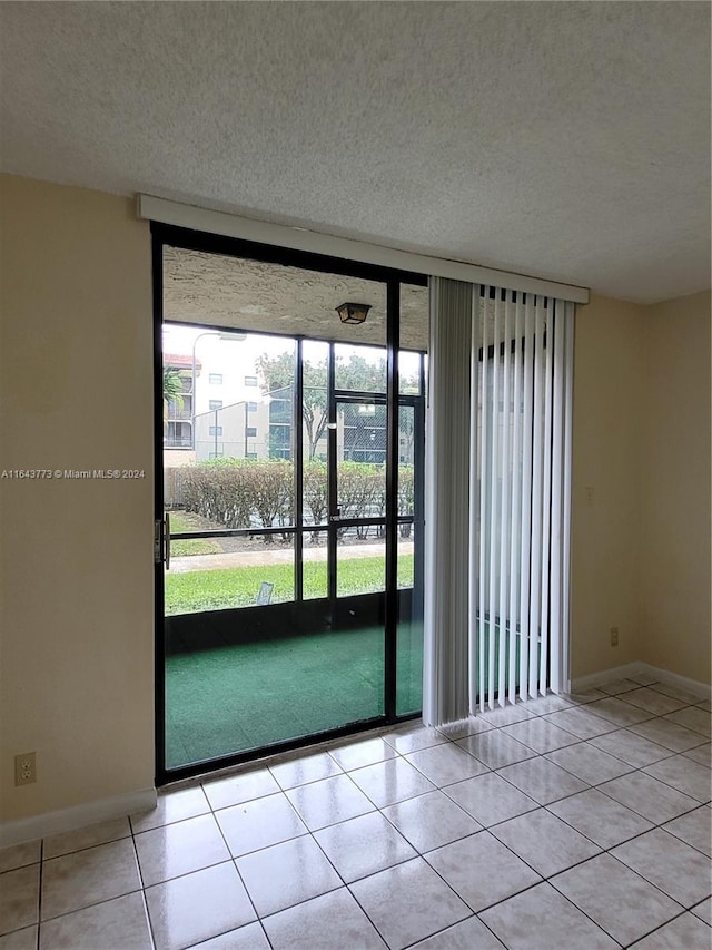 tiled spare room featuring golf simulator and a textured ceiling